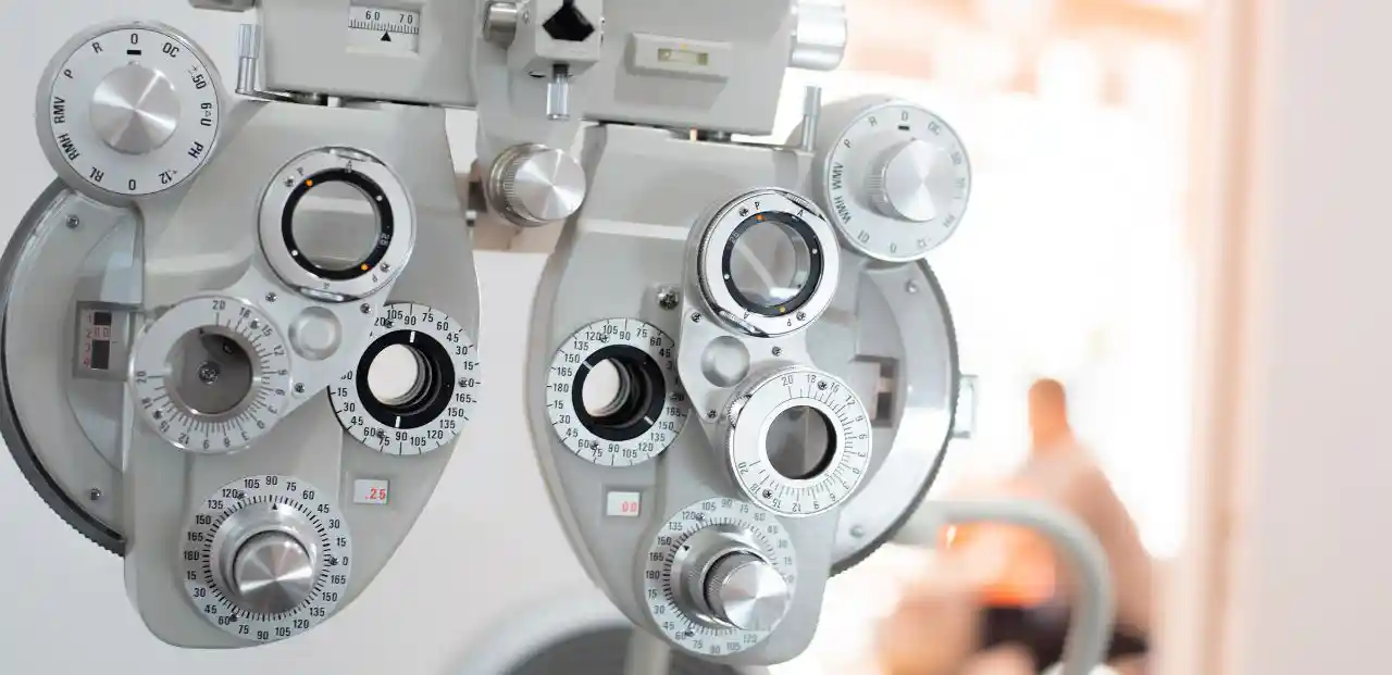 A photo of a phoropter, an instrument comprised of cylinders, prisms, and lenses that measures the eye's refractive error to help determine and eye prescription.